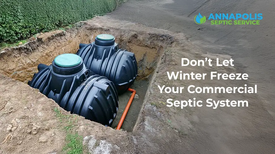 Technician performing commercial septic tank cleaning and inspection in winter